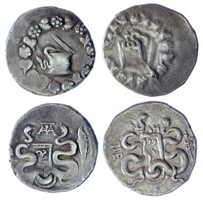 four silver coins with designs on them on a white background
