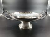 a silver bowl with handles on a black table