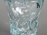 a glass vase with a design on it on a table
