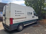 a white van parked in front of a building