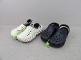 two pairs of crocs on the floor next to each other
