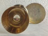 two brass vases sitting next to each other on a table