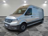 the silver van is parked on a checkered floor in a room