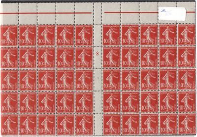 a close up of a red and white envelope with stamps on it