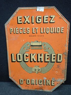 un panneau orange sur lequel est inscrit « exigez pièces et liquide »