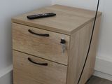 a wooden cabinet with a remote on top of it