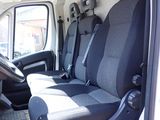 the interior of a white van with black seats and a steering wheel