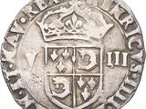 a close up of a coin with a crown on top of it