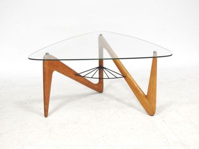 a glass top coffee table with wooden legs and a triangular glass top
