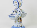 figurine of a woman holding a basket of flowers