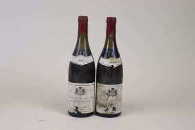 two bottles of wine sitting next to each other on a white surface