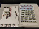 an open book with stamps on it sitting on a table