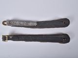 two knives that are laying on a white surface