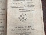 an old book open on a table on a wooden table