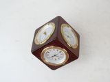 a small wooden clock on a white surface