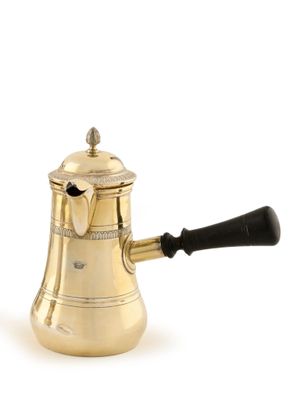 an antique brass coffee pot with a black handle on a white background