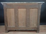 a wooden cabinet with a metal top on the floor