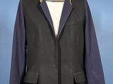 jacket on a mannequin stand against a blue background
