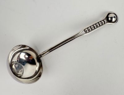 an image of a spoon with a metal handle on a white surface