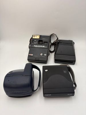 an image of a camera and other electronics on a white surface