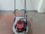 an image of a lawn mower parked in a garage