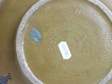 a yellow plate with a blue design on it