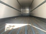 an image of the inside of a truck with wood flooring
