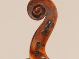 an old violin with a long neck and a long tail