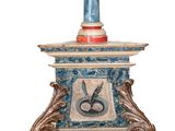 a blue vase with a bird on top of it