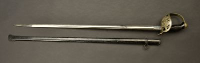 an old sword and a small sword on a table