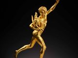 a gold figurine of a man holding a child
