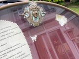 a glass table with a plaque on it in front of a house