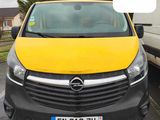 a yellow van parked in a parking lot with a number 11 on the front