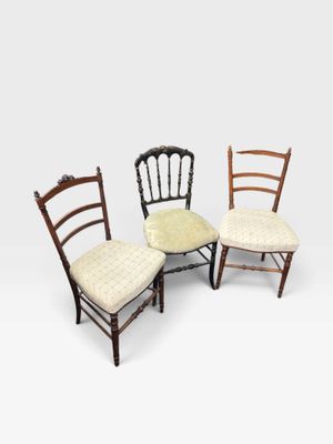 a set of four chairs with upholstered cushions
