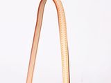 someone is holding a brown purse with a strap on it