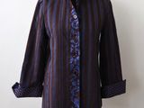 purple and blue striped shirt on a mannequin stand