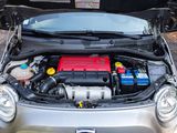 a small car with its hood open and a battery in the trunk