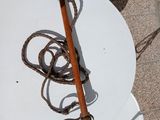 a white plate with a wooden stick and a pair of shoes on it