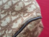 a close up of a bag on a red surface