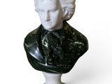 marble bust of a woman with a black jacket on a white pedestal