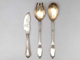 three spoons, a knife and a knife on a table
