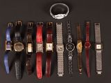 a lot of watches that are lined up on a table