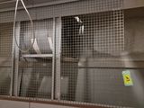 a large metal cage with a bunch of items inside of it