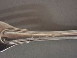 a silver spoon with a handle on a table