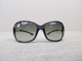 sunglasses on a table with a white table cloth and a white wall