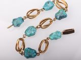 a pair of turquoise and gold bracelets with turquoise beads