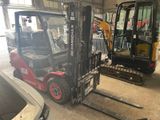 two forklifts that are parked in a garage