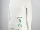 an image of a white shirt with a green design on it
