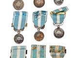 many medals and medals on display on a white surface