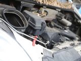 a close up of a car ' s engine with its hood open